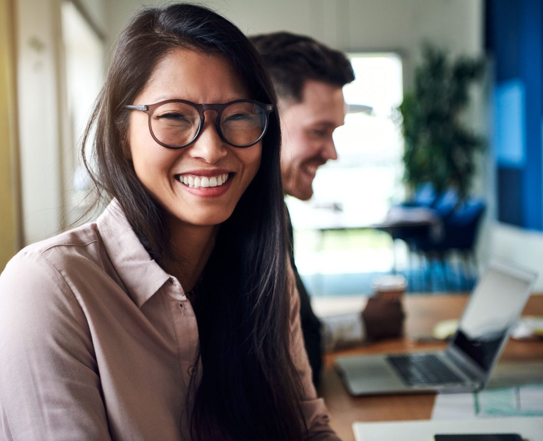 smiling-young-asian-businesswoman-sitting-with-HPT2KJZ.jpg